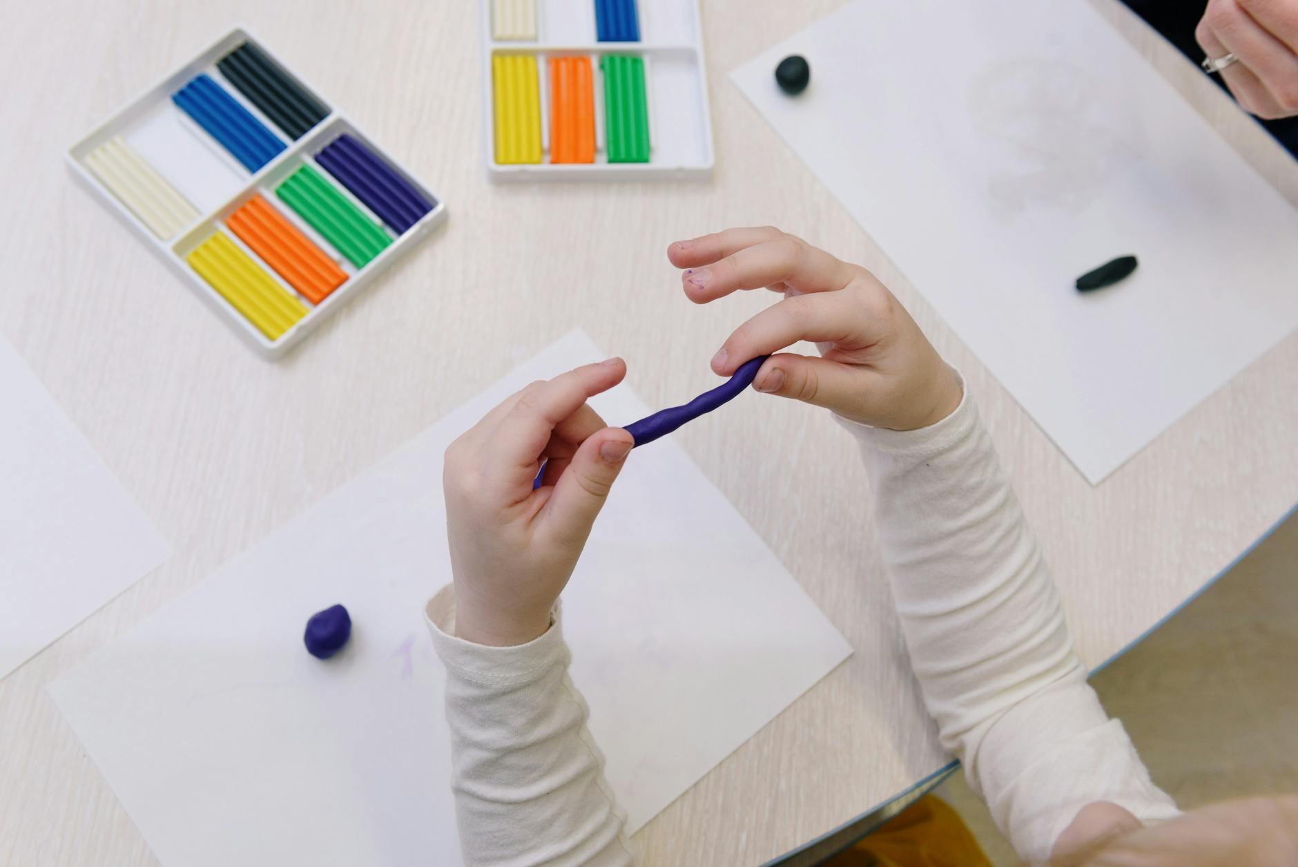 person holding blue modelling clay